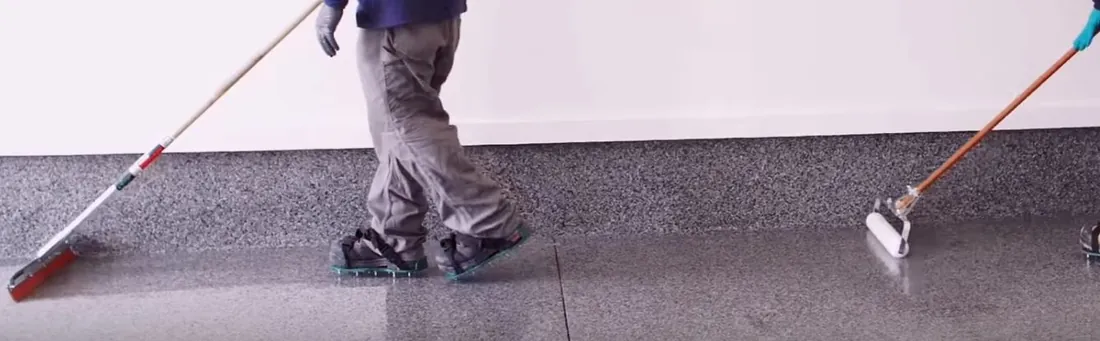 Ascent Epoxy Tampa crew broadcasting decorative flakes onto a fresh epoxy garage floor