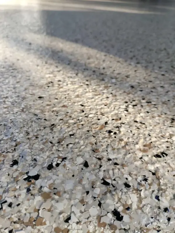 Garage tan and black flake epoxy floor close-up